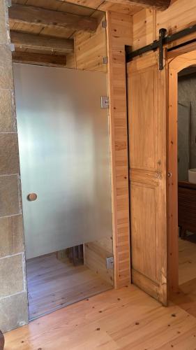 an open door in a room with a wooden floor at La Cà di Tonia e Abigaille in Songavazzo