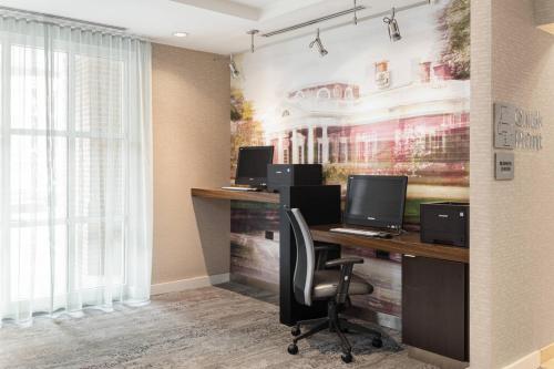 an office with three desks with computers on them at Courtyard Charlottesville - University Medical Center in Charlottesville