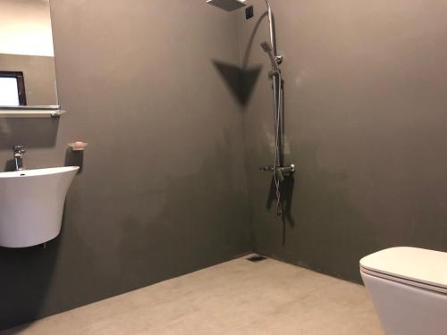 a shower stall in a bathroom with a toilet at Murphy's Transit Villa Airport Pick & Drop Katunayake in Katunayake
