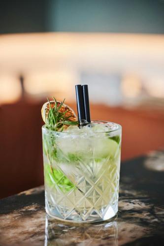 a glass of water with a drink with a stick at Courtyard by Marriott Gdynia Waterfront in Gdynia