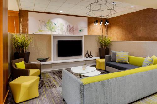 a living room with a couch and a tv at Courtyard by Marriott Boston Logan Airport in Boston