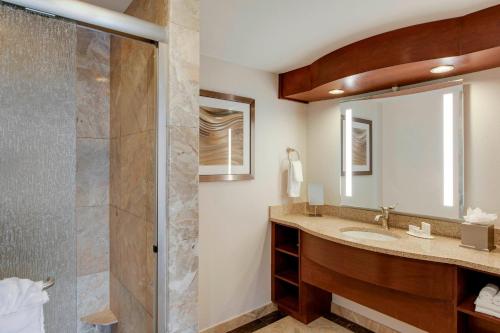 a bathroom with a sink and a shower at Courtyard by Marriott Boston Logan Airport in Boston