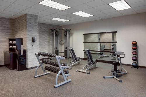 a gym with treadmills and machines in a room at Courtyard by Marriott Boston Logan Airport in Boston