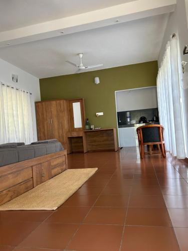 a living room with a couch and a table at Mahogany by Exuberance Stays in Wayanad