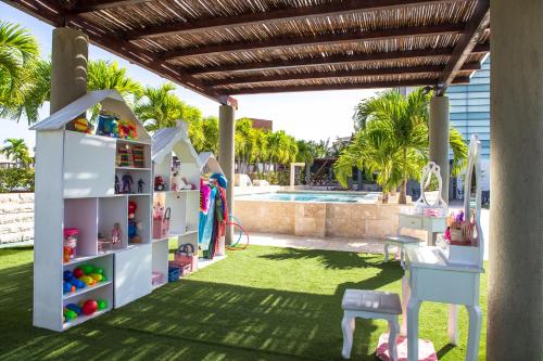 a resort yard with a pool and a table and chairs at SUNSOL UNIK Luxury Hotel in Porlamar