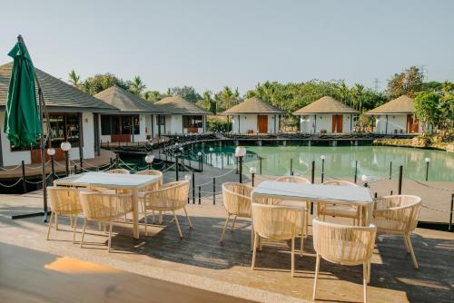 a table and chairs in front of a pool at Ellipse Boutique Phayao in Phayao