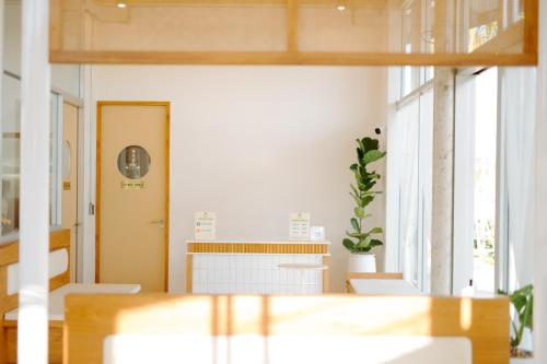 an empty room with a table and a door at Ellipse Boutique Phayao in Phayao