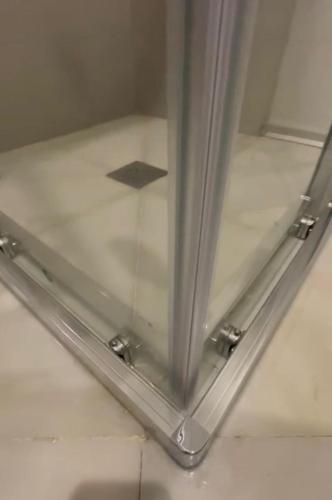 a glass door with a metal frame on a floor at Apartamentos GADIR CENTRO in Cádiz