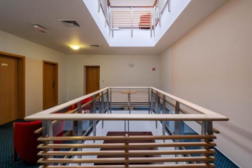 an empty room with stairs and a ceiling at Hotel Slovan in Jeseník