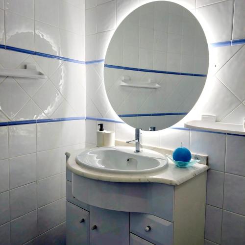 a bathroom with a sink and a mirror at Apartamento Torre da Medronheira in Olhos de Água