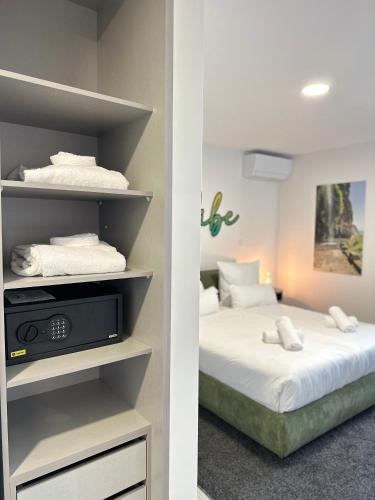 a bedroom with two beds with white sheets at The Vibe Madeira Apartment 2 in Arco da Calheta