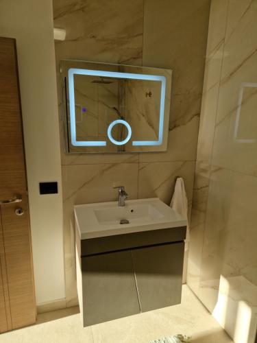 a bathroom with a sink and a mirror at Vila Timeea in Statiunea Borsa