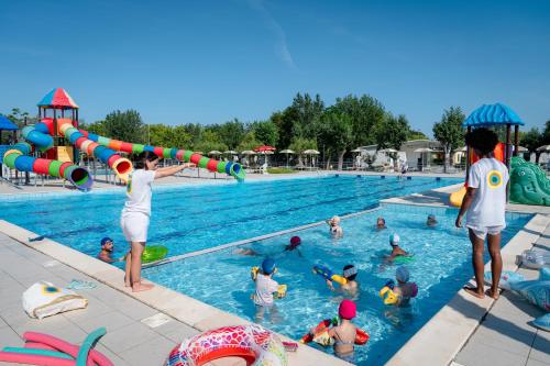 a group of people playing in a swimming pool at Club del Sole Stork Family Collection in Giulianova