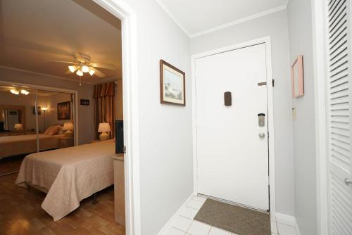 a room with a bed and a door leading to a bedroom at Sandpiper Cove 2043 in Destin