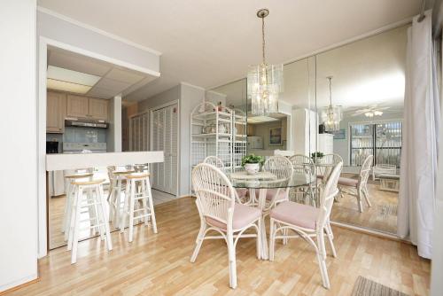 a kitchen and dining room with a table and chairs at Sandpiper Cove 2043 in Destin