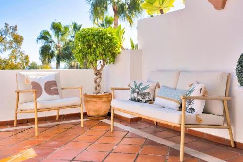 two chairs and a couch on a patio at Luxury Duplex Penthouse Sea Views in Marbella Golden Mile in Marbella