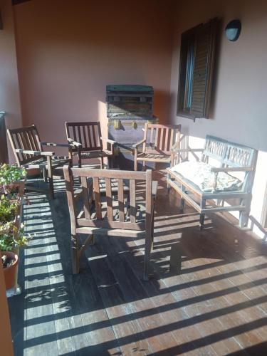 a group of chairs and a table on a deck at Villa Erbetta in Guardabosone