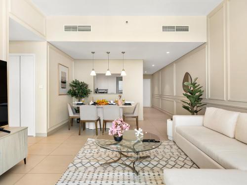 a living room with a couch and a table at Brand New! Downtown views located on Dubai Mall in Dubai