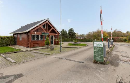 a small building with a sign in front of it at 2 Bedroom Beautiful Home In Wagenborgen in Wagenborgen