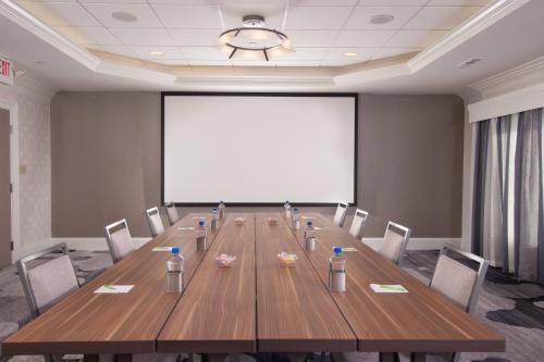a large conference room with a long wooden table and chairs at Courtyard Charleston Waterfront in Charleston