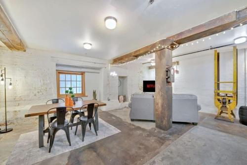 a dining room with a wooden table and chairs at Chic Downtown Condo in Knoxville's Old City in Knoxville