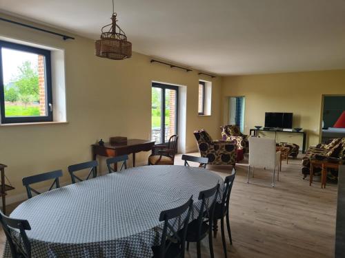 a living room with a table and chairs at La Maison d'Armand in Doudeville