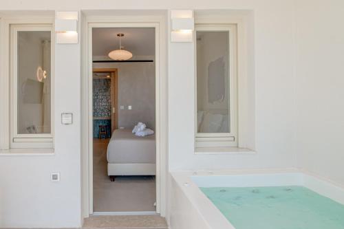 a bathroom with a bath tub in a room at Apeiron Blue Santorini - Sustainable Adults Only 14 Plus in Fira