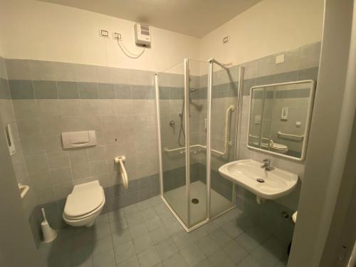a bathroom with a shower and a toilet and a sink at Ostello Città di Rovereto in Rovereto
