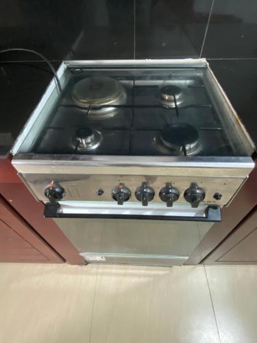 a stove top oven with black burners on it at Coastal Heaven in Bentota