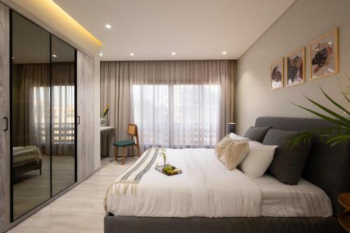 a bedroom with a large bed and a couch at Degla by Spacey # 39 - Studio in Maadi in Cairo