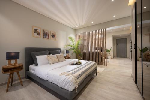 a bedroom with a large bed and a living room at Degla by Spacey # 39 - Studio in Maadi in Cairo
