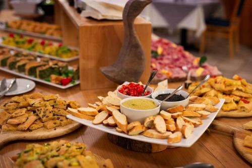 a buffet of different types of food on a table at Hotel Bellamonte in Predazzo