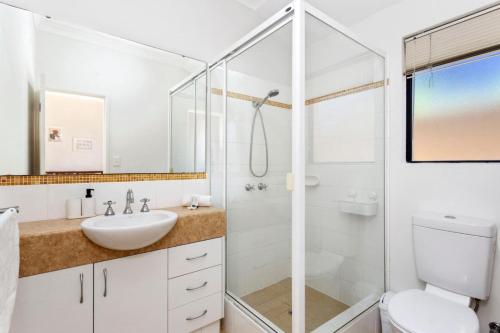 a white bathroom with a sink and a shower at Beachside Gem in Doubleview, Free Wi-Fi, Parking in Perth