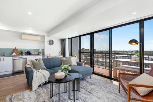 a living room with a couch and a table at City Chic, Elegant 2BR apt in Perth