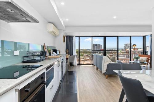 a kitchen and living room with a view of the city at City Chic, Elegant 2BR apt in Perth