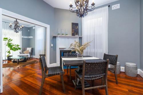 a dining room with a table and chairs at Fusion of 20th century charm and modern convenience in Perth