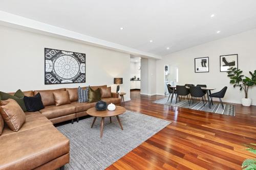 a living room with a couch and a table at Sasha's Cottage on the Hill BBQ & Entertainment in Perth