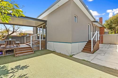 a home with a patio and a porch with a table at Sasha's Cottage on the Hill BBQ & Entertainment in Perth