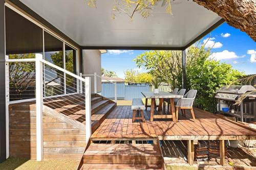 a deck with a table and chairs on a house at Sasha's Cottage on the Hill BBQ & Entertainment in Perth