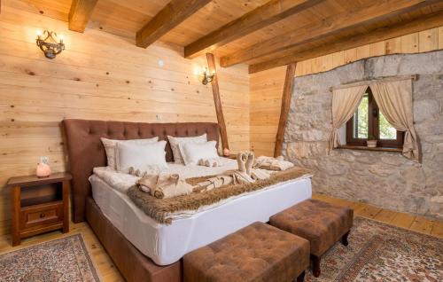 a bedroom with a bed in a log cabin at Awesome Home In Gracac With Sauna in Gračac
