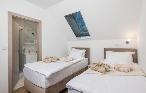 two beds sitting next to each other in a room at Awesome Home In Gracac With Sauna in Gračac
