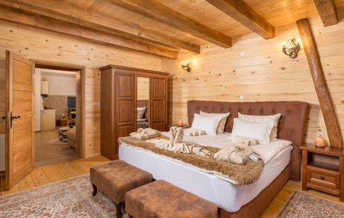 a bedroom with a bed in a log cabin at Awesome Home In Gracac With Sauna in Gračac