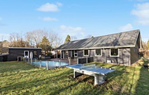 a house with a ping pong table in front of it at Beautiful Home In Glesborg in Glesborg