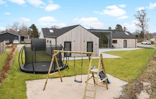 a playground in the yard of a house at Gorgeous Home In Glesborg With Sauna in Glesborg