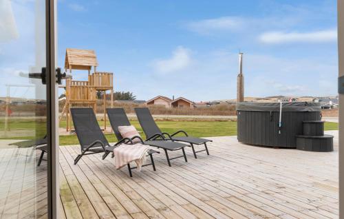 a group of chairs sitting on top of a deck at Pet Friendly Home In Løkken With Sauna in Løkken