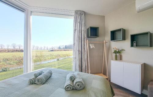 a bedroom with a bed with a large window at Nice Home In Afferden With Wifi in Afferden