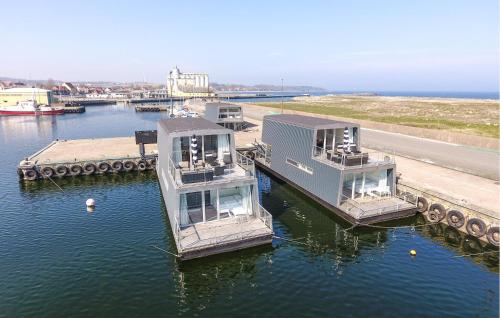 two boats docked at a dock in the water at 3 Bedroom Amazing Ship In Nexø in Neksø