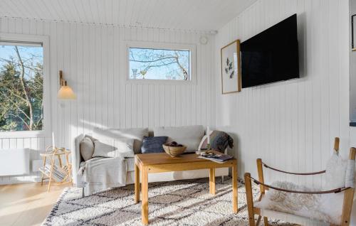 a living room with a couch and a table at 3 Bedroom Gorgeous Home In Stege in Stege