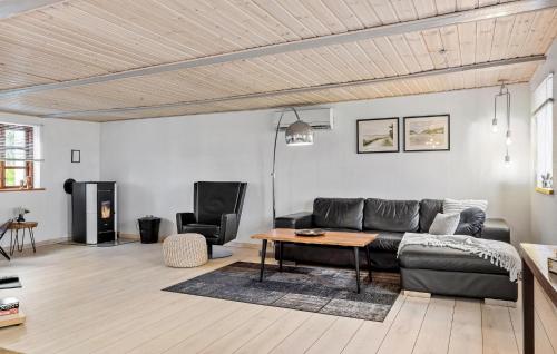 a living room with a couch and a table at 2 Bedroom Beautiful Home In Bogense in Bogense