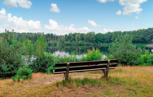 a park bench sitting in front of a lake at 2 Bedroom Stunning Home In Afferden in Afferden
